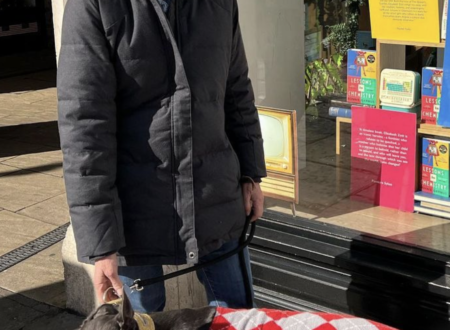 Author Bonnie Garmus outside a bookstore displaying Lessons in Chemistry