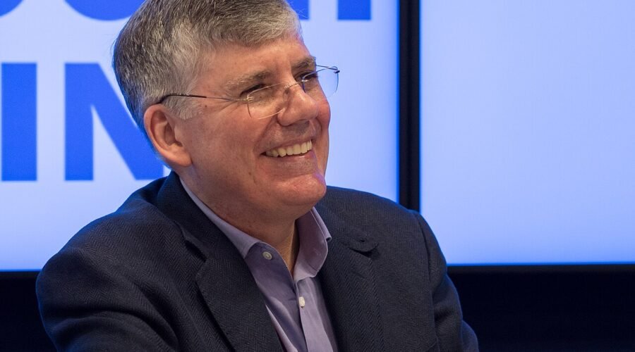Author Rick Riordan smiling at an event